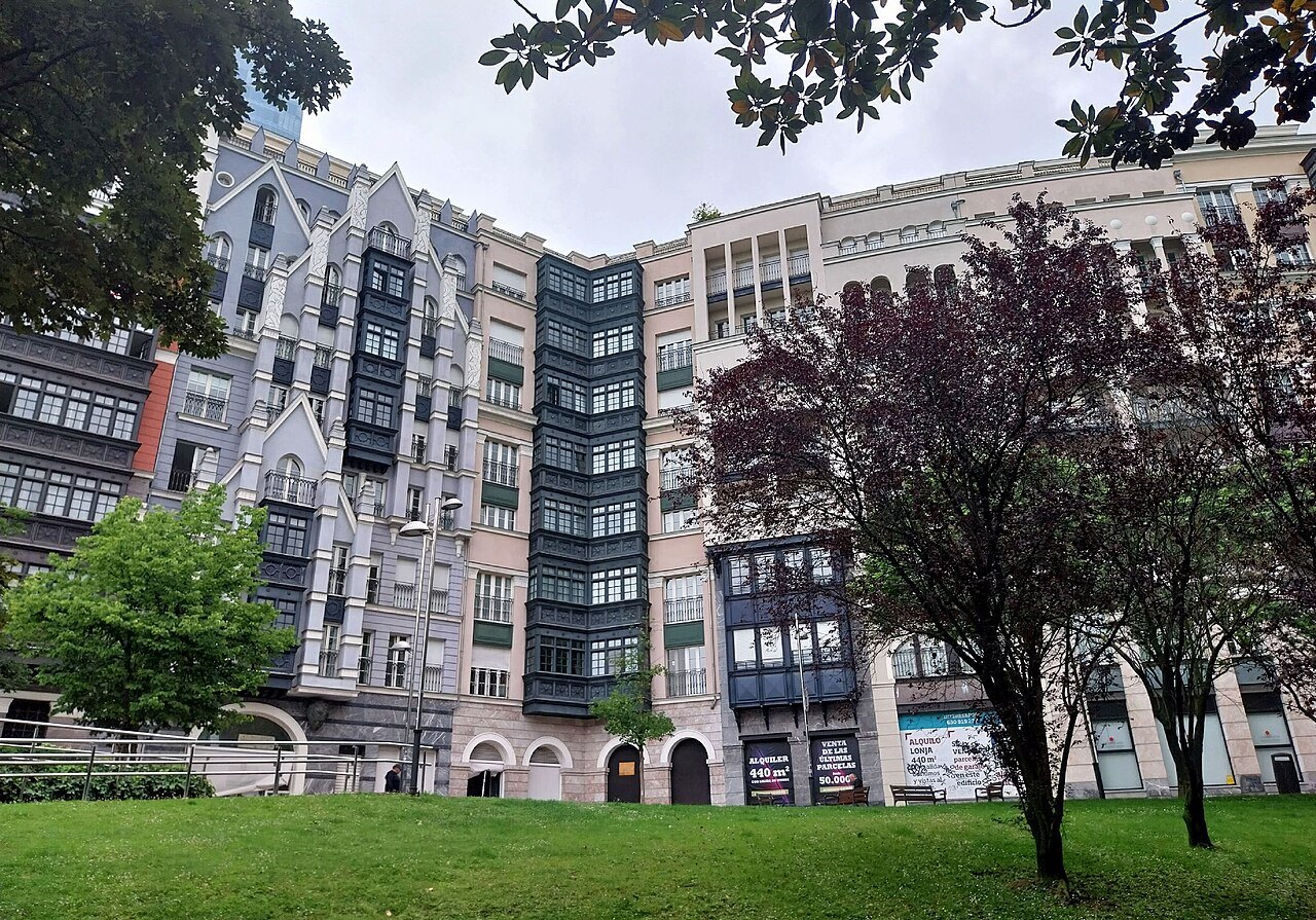 The Artklass apartment buildings with their glazed bay windows, behind a lawn and trees