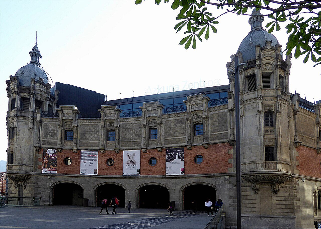 Azkuna Zentroa from its square, banners hung between the arches