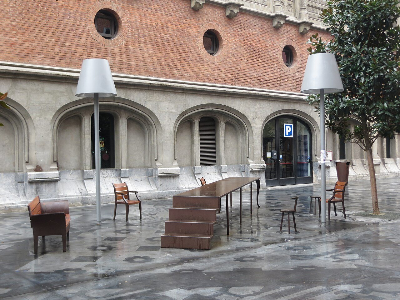 Tall standing lamps and a sculpted table on the square beside Azkuna Zentroa