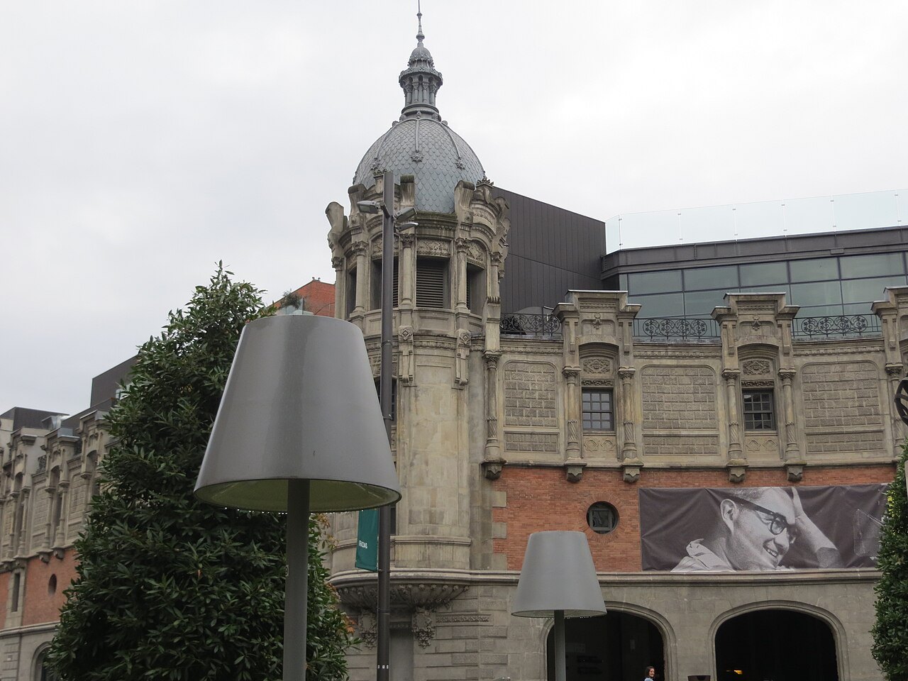 The corner tower and arcades of Azkuna Zentroa beside the square
