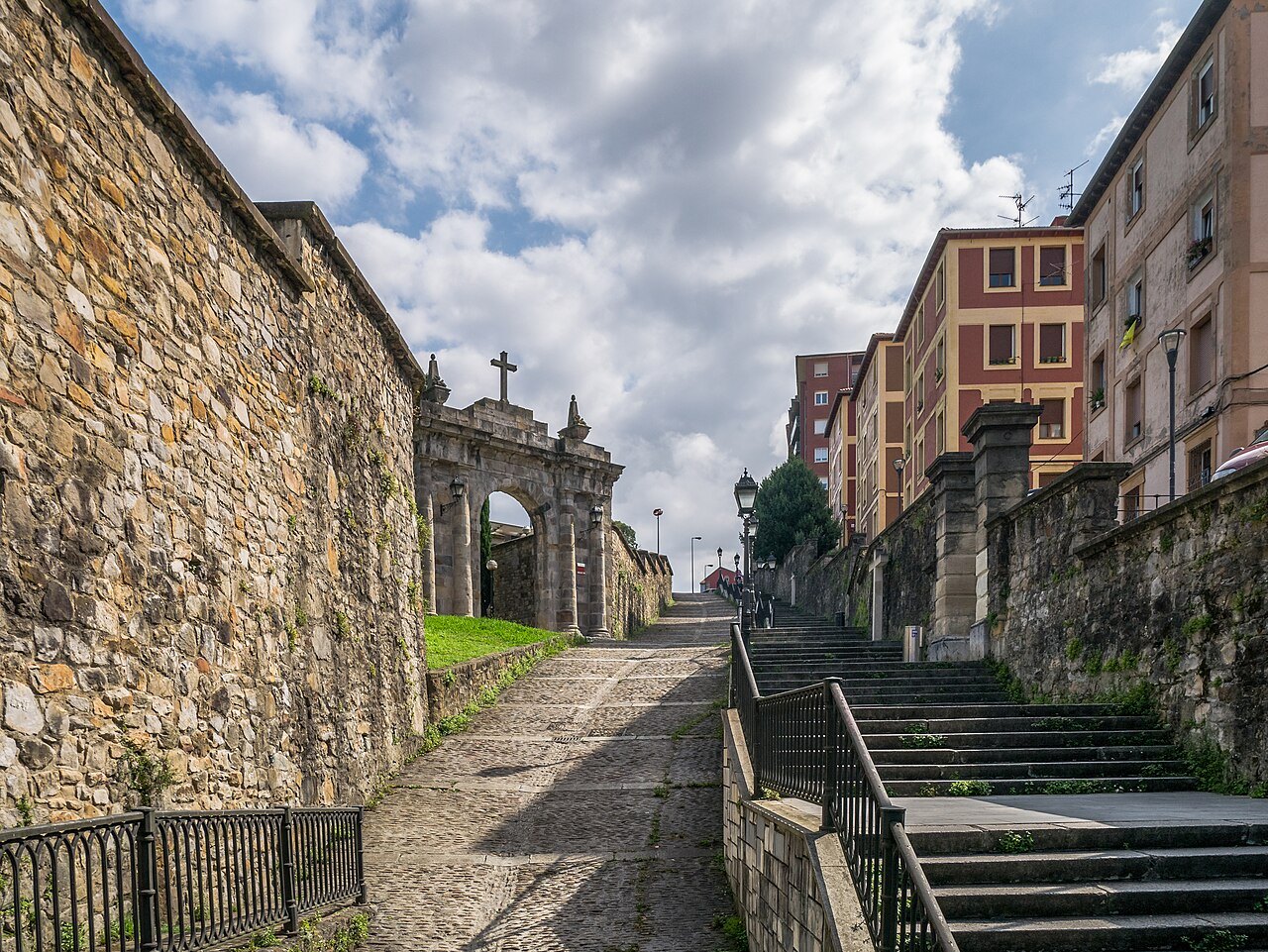 The old cobbled way of the Calzadas de Mallona climbing beside a stone wall toward Begoña