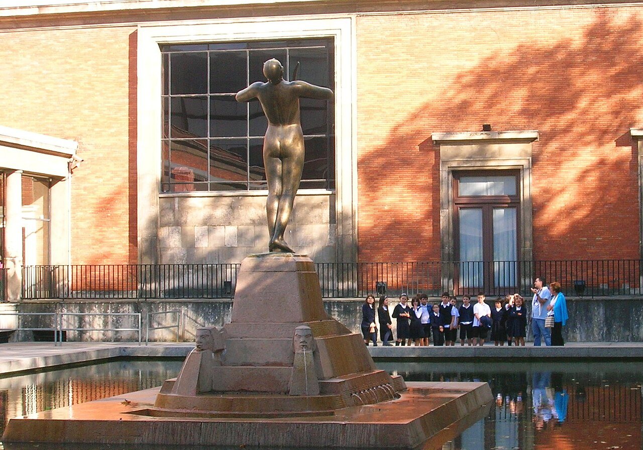 The bronze statue of the composer Arriaga by the museum pool, a school group behind