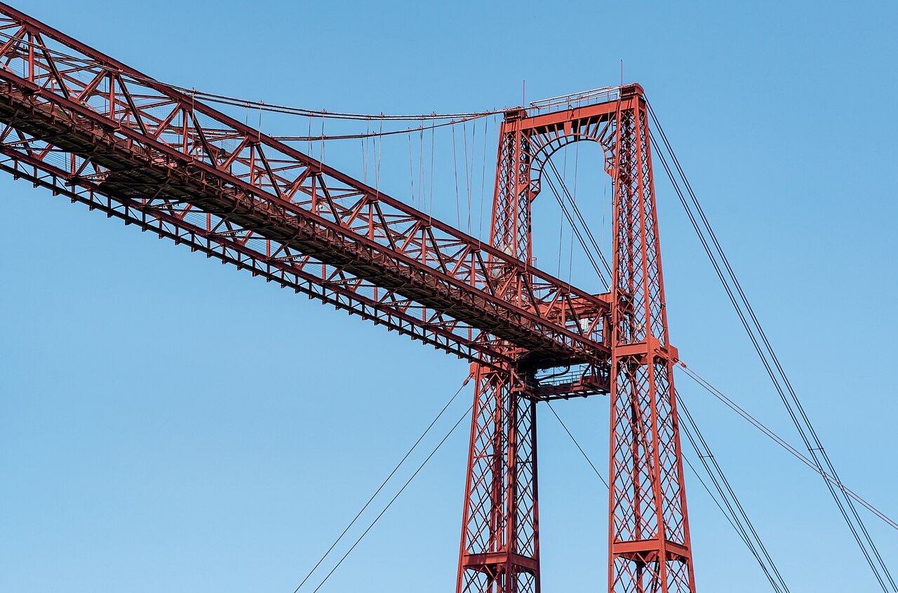 The Bizkaia Bridge's red girder and tower against the sky