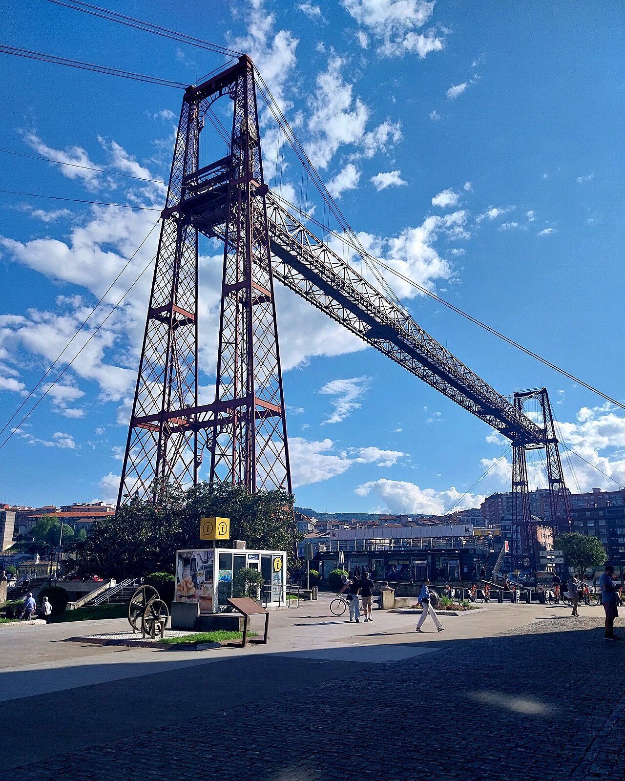 A tower of the Bizkaia Bridge rising over the square at Las Arenas