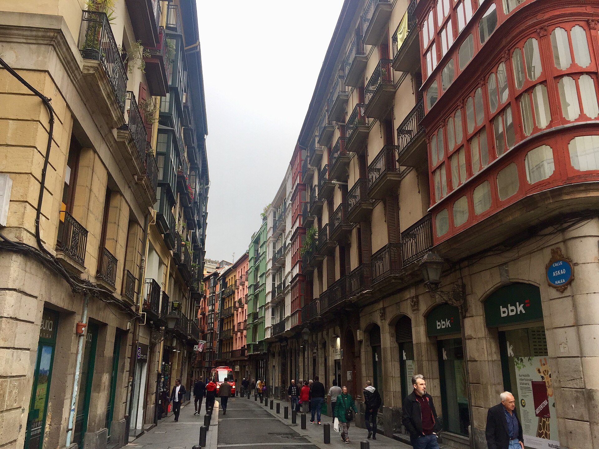 Calle Askao, its red and green glazed balconies running away down the street