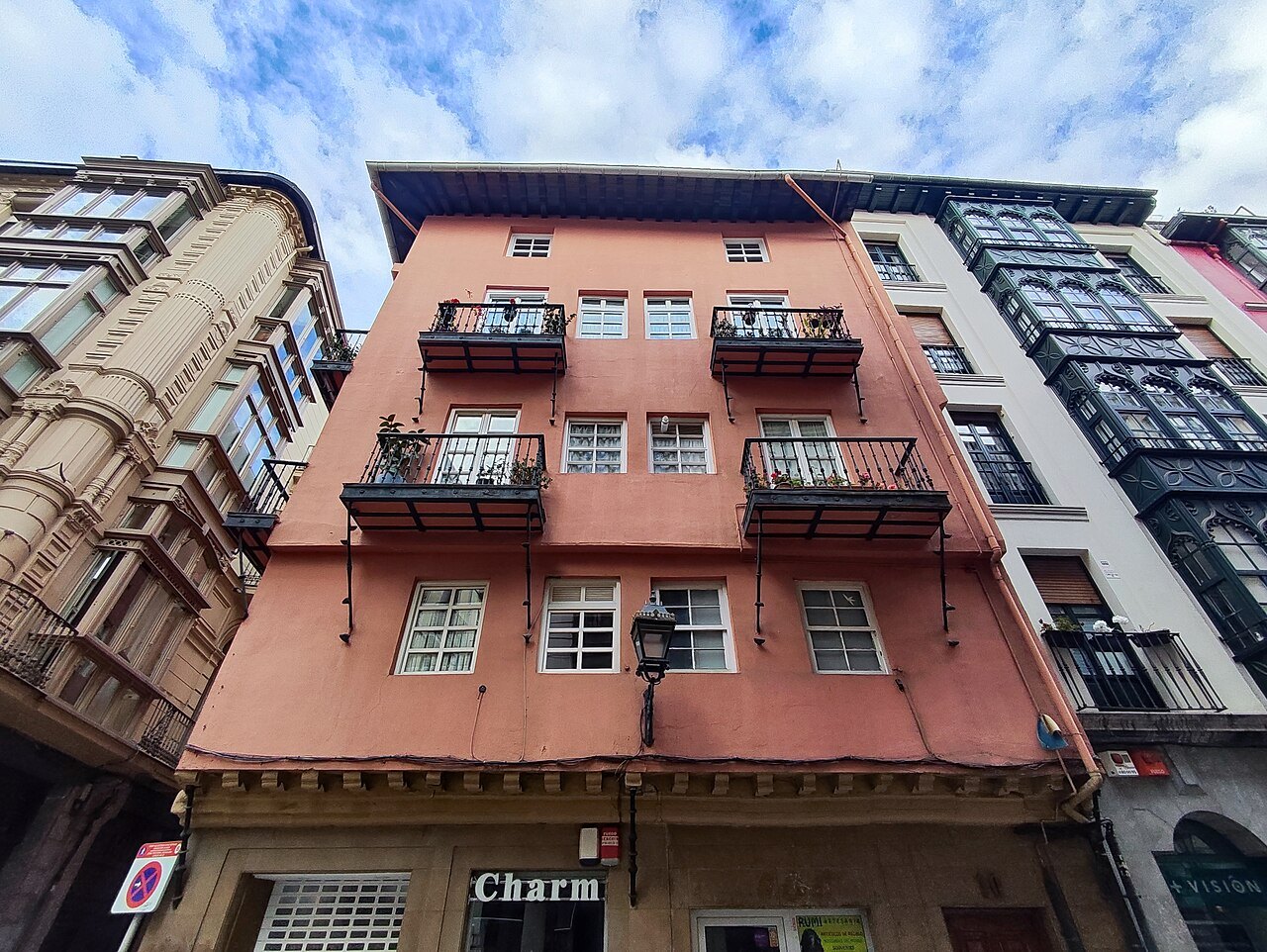 The pink-washed Casa Rosa on a corner of the old town, with iron balconies