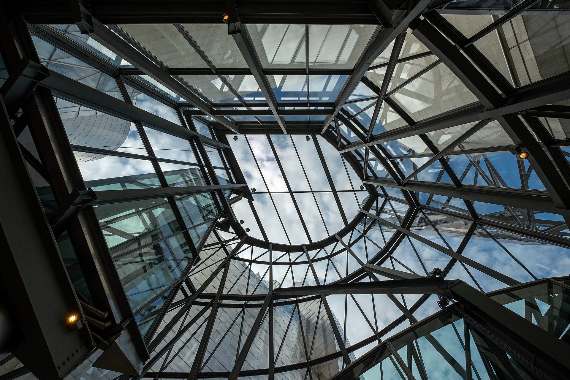 The glass and steel roof over the entrance of the Guggenheim, seen from below