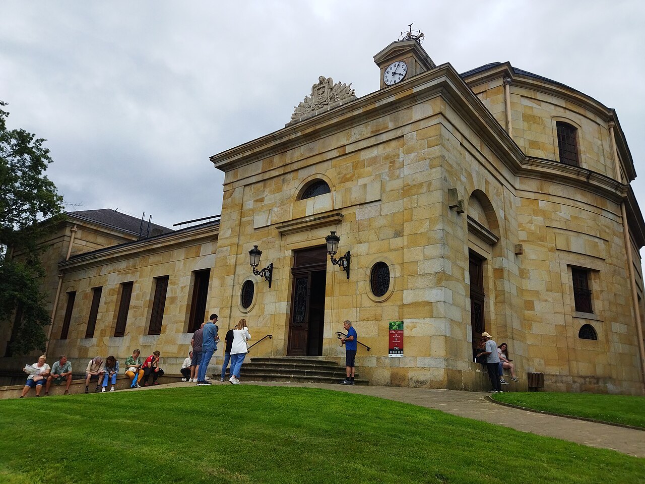 The stone Assembly House of Biscay at Gernika, visitors on its lawn