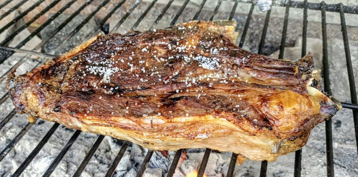 A thick beef chop, txuleta, on the grill