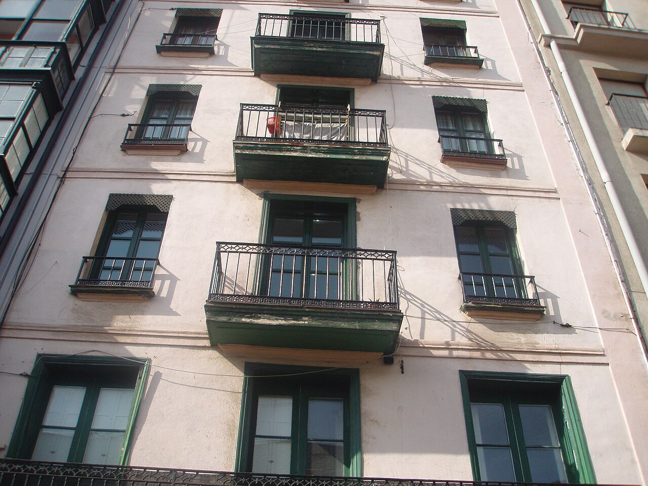 A plain house front with iron balconies at the foot of the Mallona steps