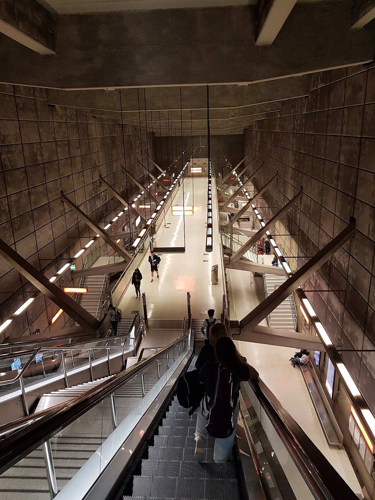 Looking down the long escalators into the cavern of a Metro station