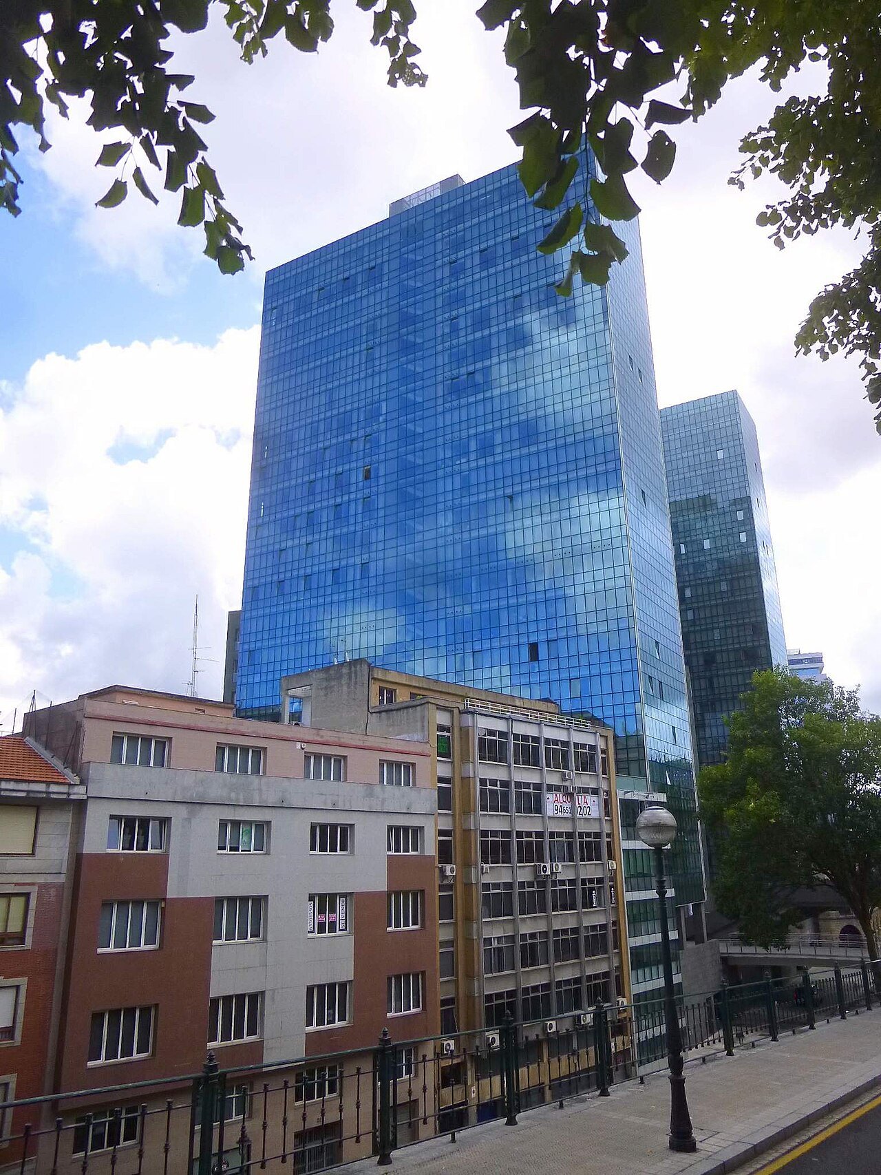 The glass towers of Isozaki Atea above older brick buildings