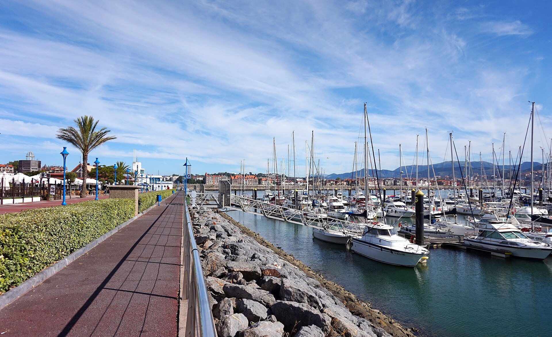The marina at Getxo, a brick walkway beside the moored yachts