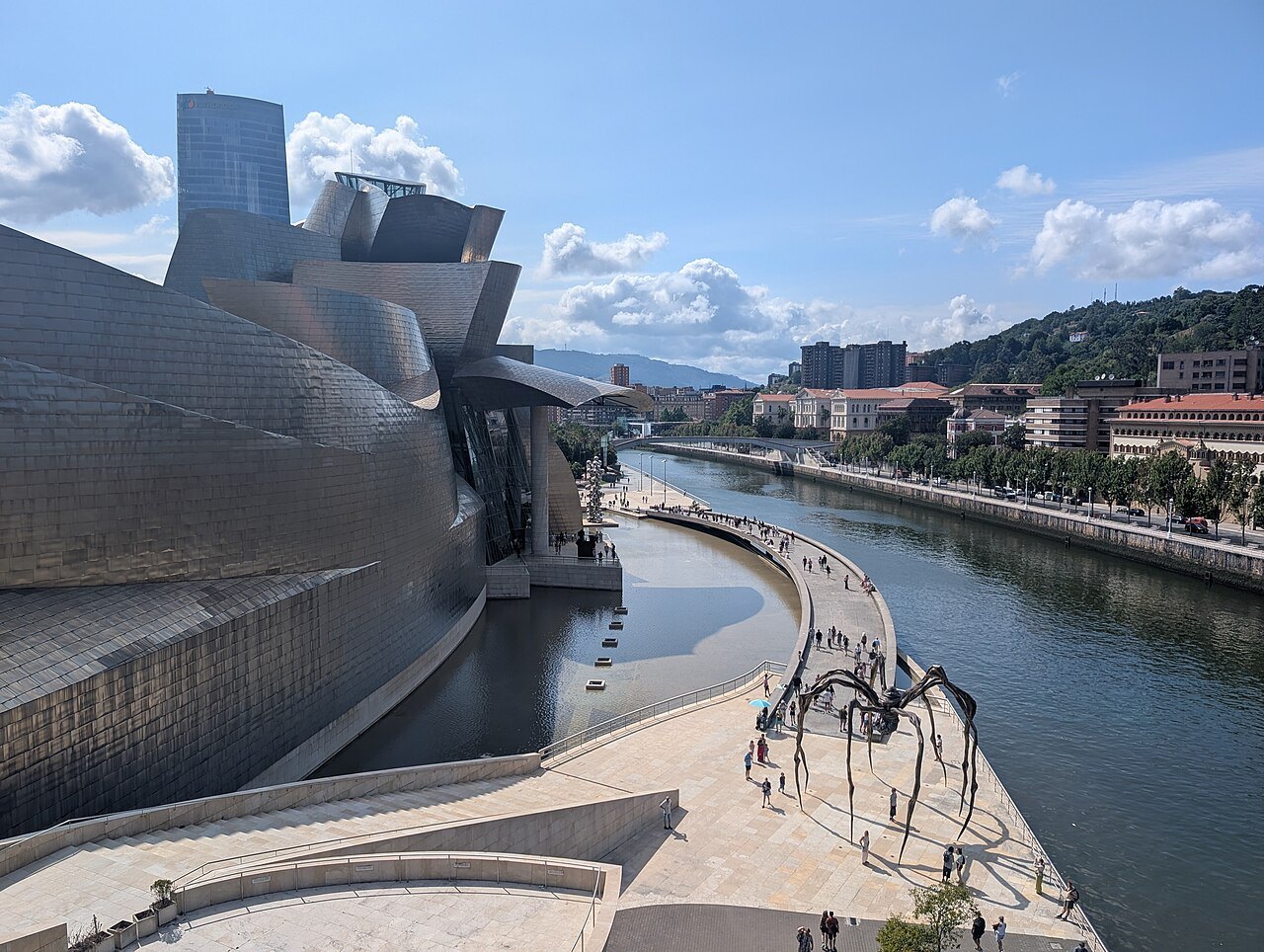 The titanium flank of the Guggenheim beside the river walk, the spider Maman on the quay