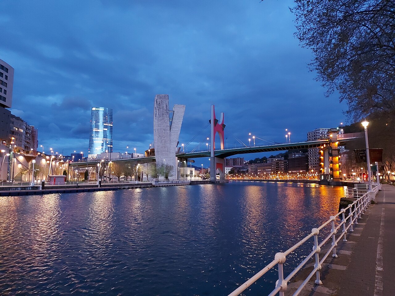 La Salve bridge and the Iberdrola Tower lit at dusk across the water