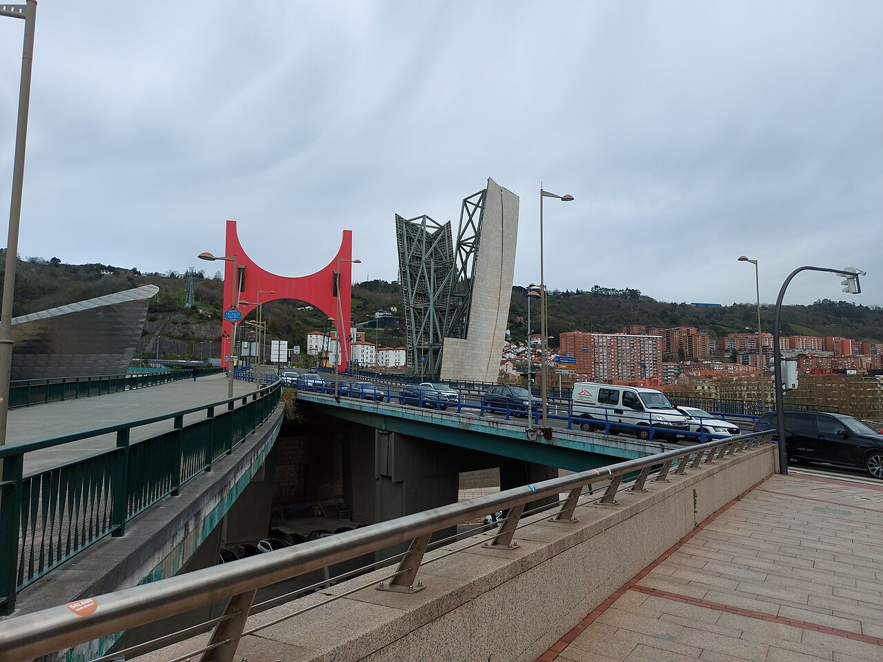 The deck of La Salve bridge with its red arch and stair tower
