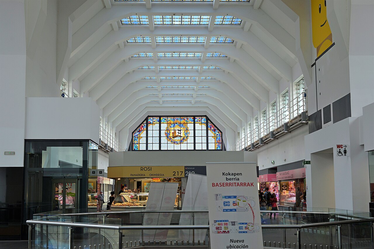 Inside the Ribera market, the hall lit by its skylights and great stained-glass window