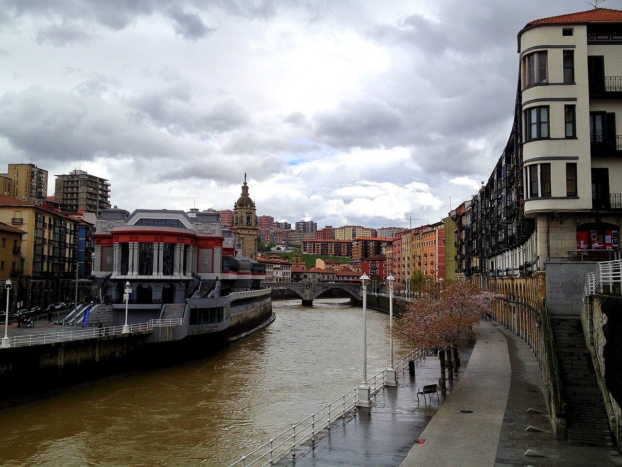 The Ribera market on its quay, the San Antón church tower beyond, on a gray day