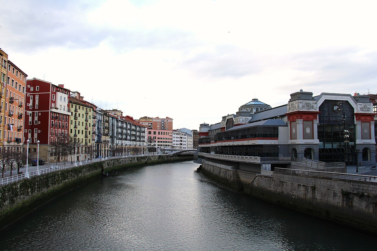 The Ribera market's long front on the right bank, at the upstream end of the Ría