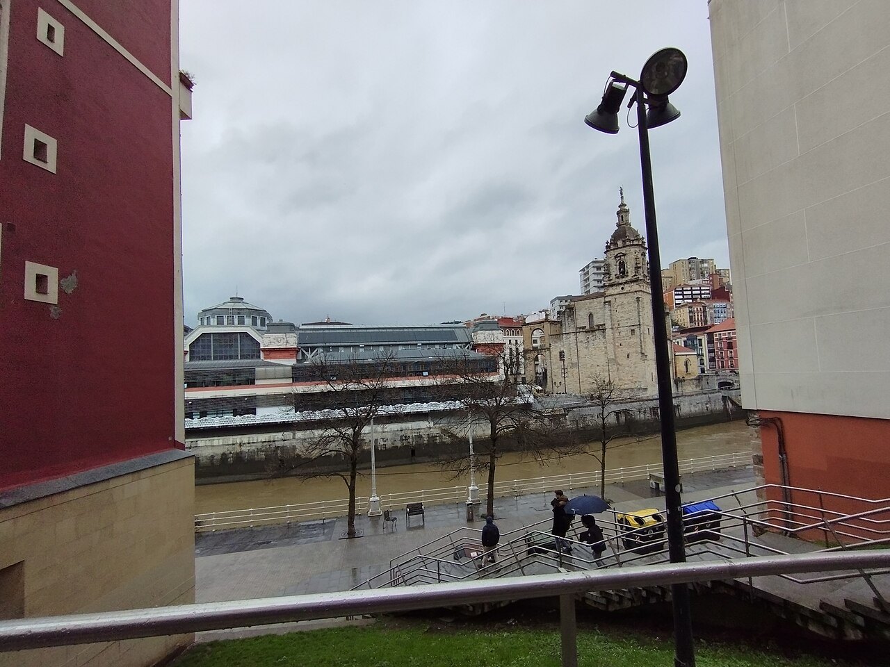 The Ribera market and the San Antón church seen across the river on a rainy day