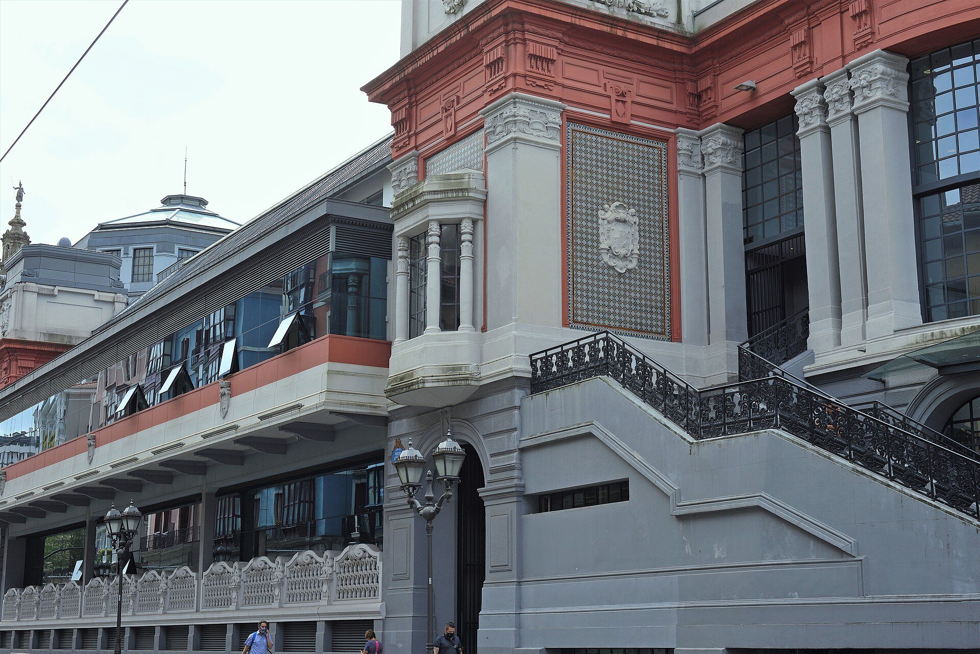 The Mercado de la Ribera, its red and white front and stairs above the river