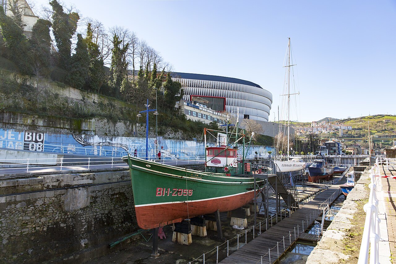 A green fishing boat on the slipway of the old yard, San Mamés beyond