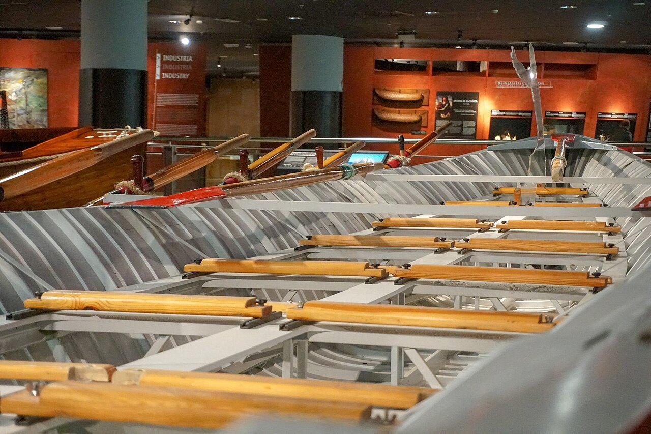 A wooden racing trainera laid out inside the Itsasmuseum