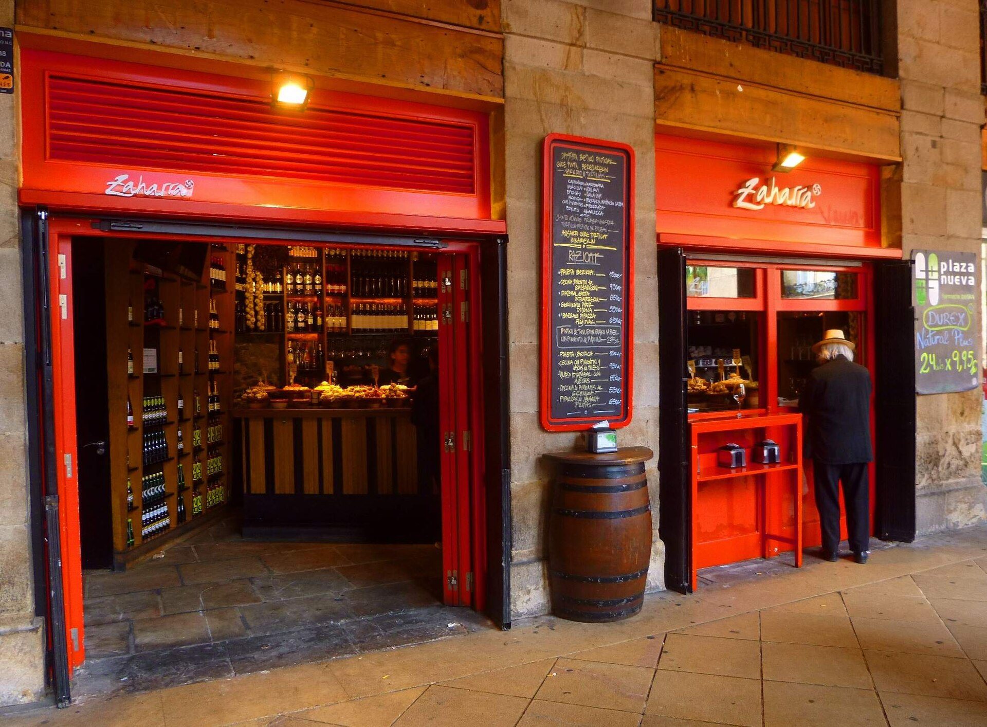 Red-painted bars under the arcades of the Plaza Nueva