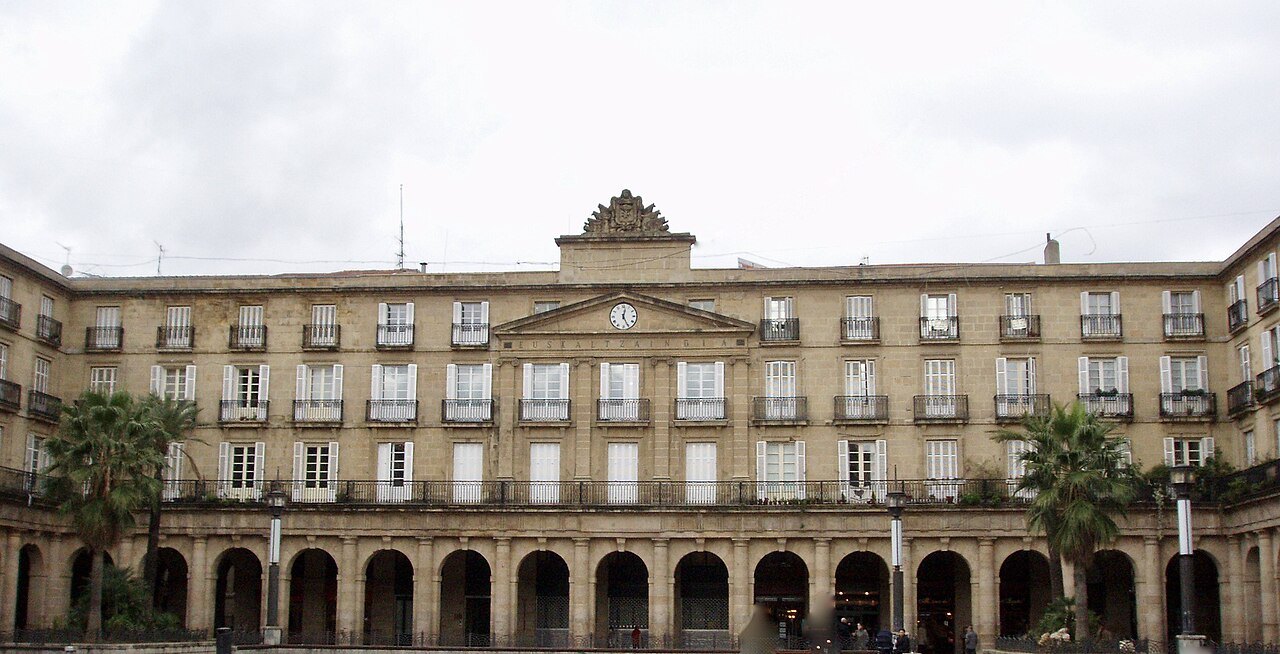 The arcaded Plaza Nueva, the clock building of the Basque language academy at its center