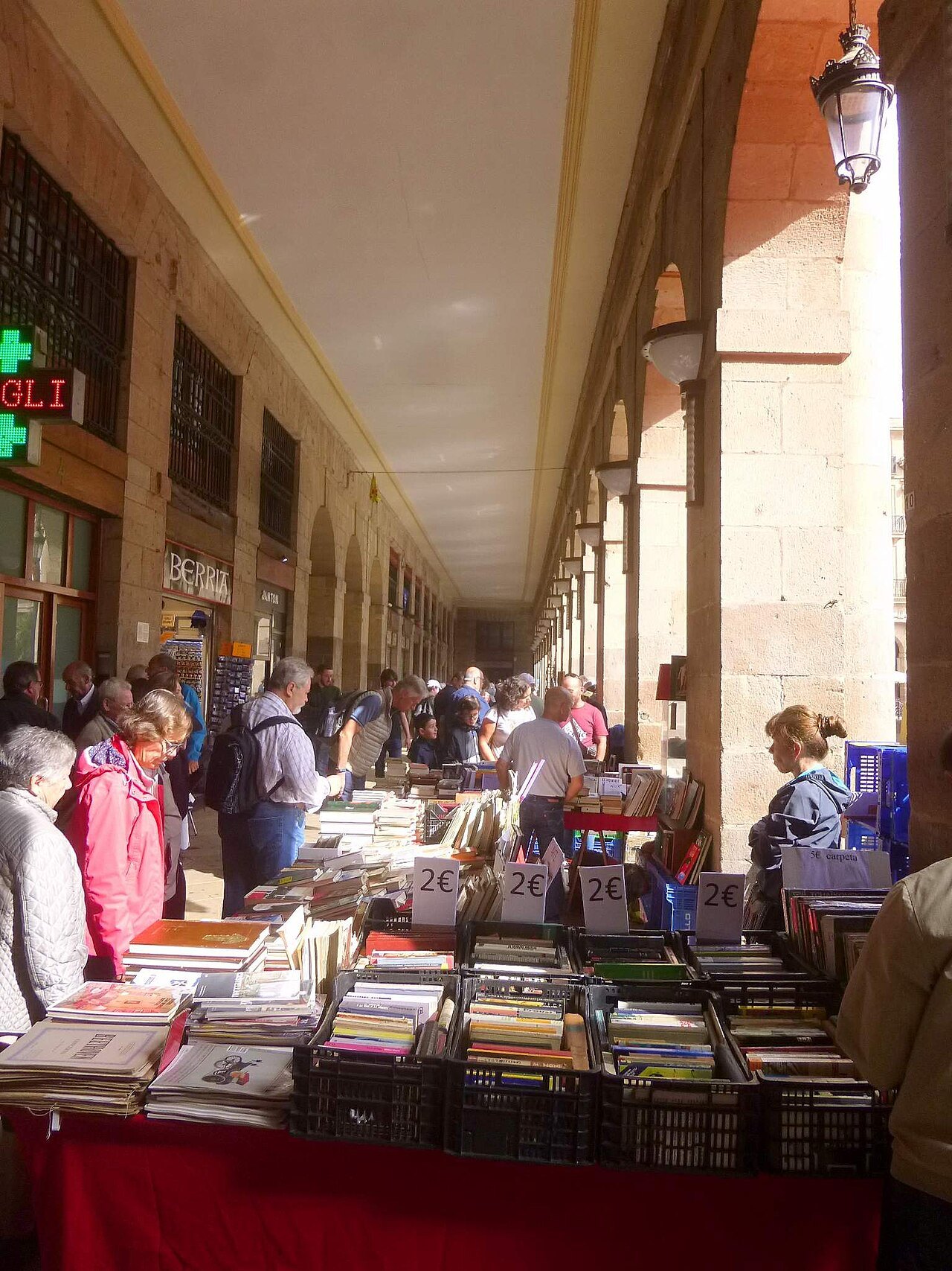 Book stalls of the Sunday market under the arcades of the Plaza Nueva