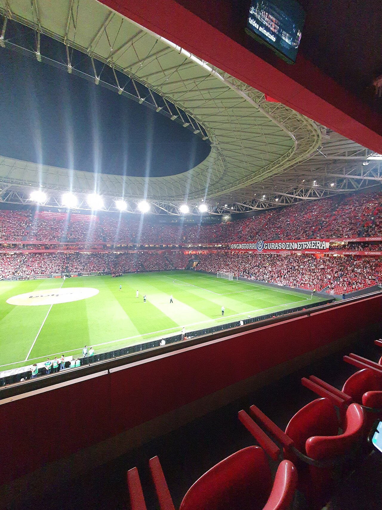 San Mamés lit for an evening match, seen from a corner of the stands