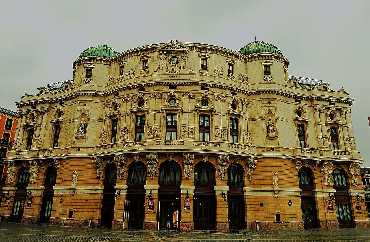The Teatro Arriaga's Neo-Baroque front and green domes in evening light